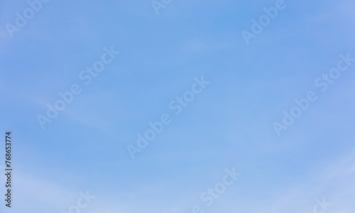 Blue sky background with few clouds.