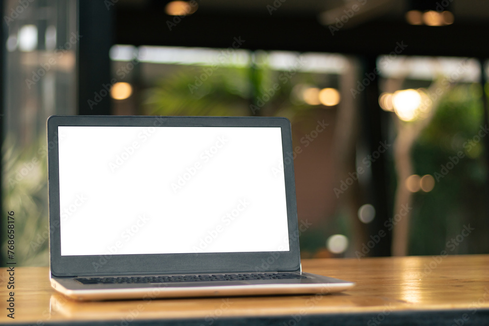 Laptop computer on desk at office or co-working space, Laptop with white blank on screen and blurred background , working space concept. Laptop computer on desk at office or co-working space, Laptop with white blank on screen and blurred background , working space concept.