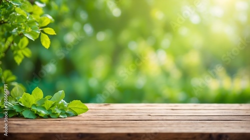 spring background with green juicy young foliage and empty wooden table in nature outdoor