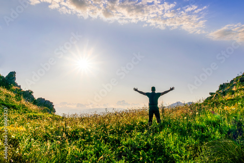 happy man watching amazing highland evening sunset  person delight with nature landscape