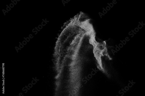Abstract dust overlay texture. Motion of white particles on black background. Powder explosion. 