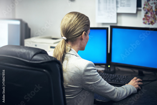 Business, woman and office for work on computer for career in corporate administration for company. Female person, back view and pc with internet for online information for developing and operations.