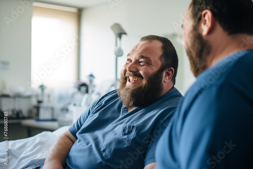 A man laughing in a hospital room