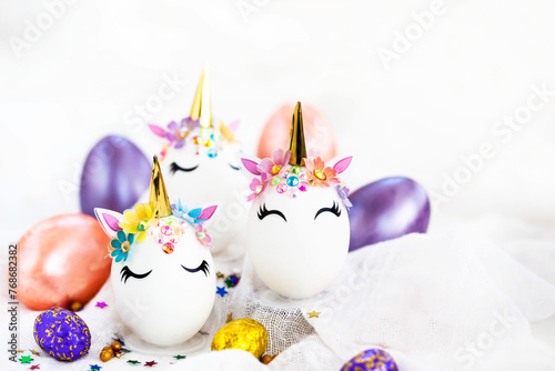 Easter eggs in the form of a unicorn on white background, copy space for text, close-up