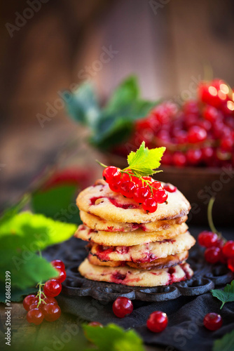 Fresh delicious redcurrant cookies on wooden rustic background