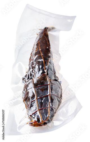 Whole hot smoked african catfish (Clarias gariepinus) vacuum packed, isolated on white background.