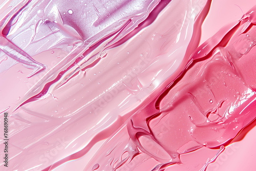 close-up swatches of transparent gel and serum cosmetic textures on a pastel pink background with a play of light and shadow 