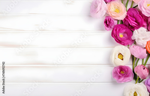 colorful Eustoma flowers on white wooden table soft light © Oleksiy