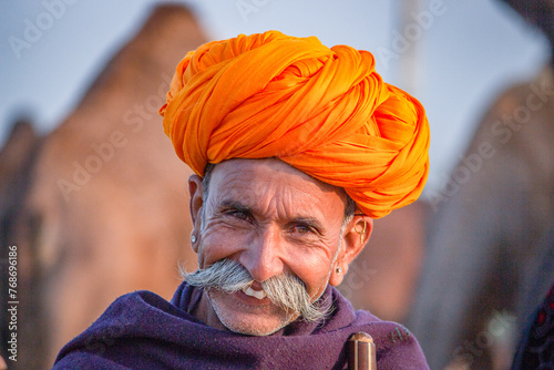 Pushkar, Rajasthan, India - November 15, 2018 Portrait of a Rajasthani Indian man dressed in traditional attire with turban (Pagadi) on his head at Pushkar camel Fair (Pushkar Mela)