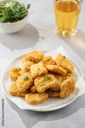 Fast food chicken nuggets paired with a glass of apple juice