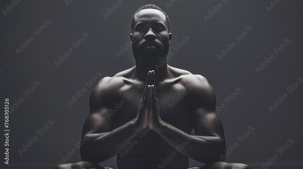 A man is sitting cross legged and praying