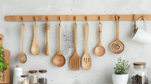 Set of bamboo kitchen utensils hanging from a wall-mounted organizer, eco-friendly and stylish.