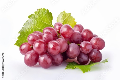 Fresh red grapes on vine with green leaves isolated on white background, healthy fruit