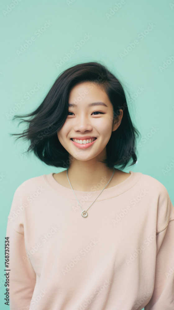 Portrait of a beautiful young asian woman smiling and looking at camera Portrait of a beautiful young asian woman smiling and looking at camera