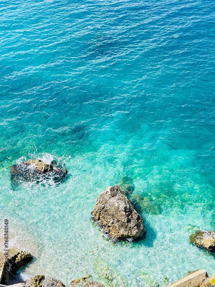 Rocky beach and crystal turquoise water of Ionian Sea in Albania.