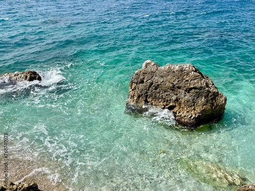 Rocky beach and crystal turquoise water of Ionian Sea in Albania.