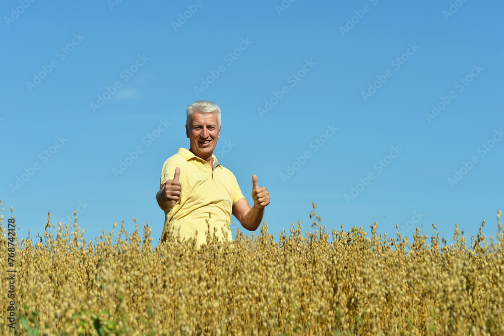 Portrait of senior man resting in field Portrait of senior man resting in field