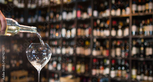 pouring white wine in a glass