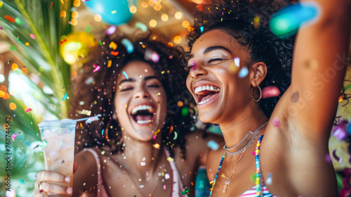 An energetic image of two women enjoying a festive atmosphere with colorful confetti and refreshing drinks