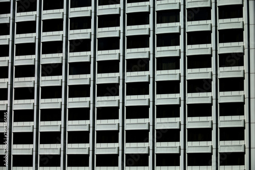 rows of symmetrical geometric windows, multi-storey buildings, arrangement of windows in multi-storey buildings.