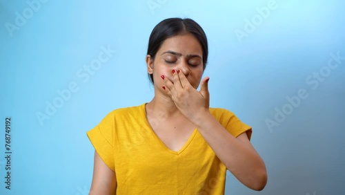 Beautiful woman practicing Anulom Vilom Pranayama, also known as Alternate nostril breathing yoga, isolated indoor home photo