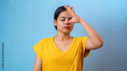 Beautiful woman practicing Anulom Vilom Pranayama, also known as Alternate nostril breathing yoga, isolated indoor home photo