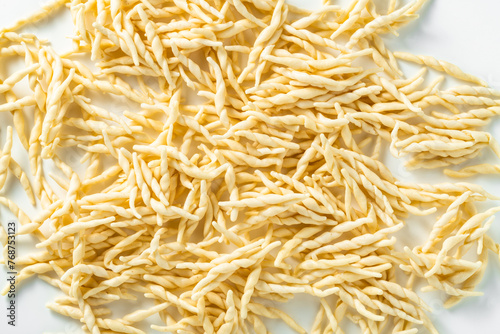 trofie . uncooked fresh Italian pasta on a white background