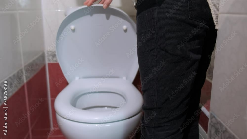 Female morning procedures by toilet bowl. A view of female with morning cystitis stand by the toilet with recycling paper in the bathroom.