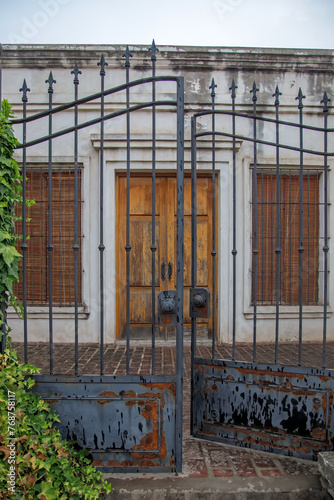 old abandoned building with wrought iron fence