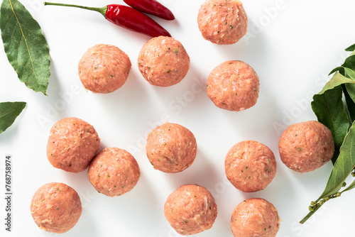 uncooked meatballs on white. product concept