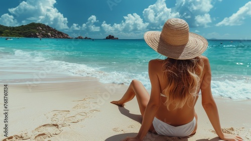Woman in Hat Sitting on Beach © olegganko