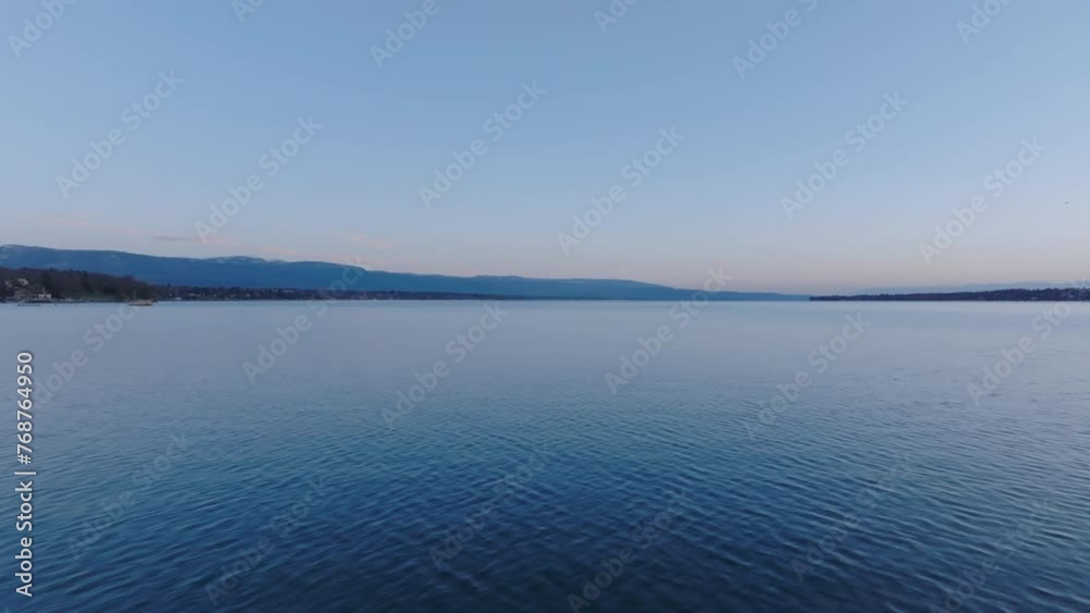 Fly above vast water surface of Geneva lake before sunrise. Aerial morning view of nature. Geneva, Switzerland Fly above vast water surface of Geneva lake before sunrise. Aerial morning view of nature. Geneva, Switzerland