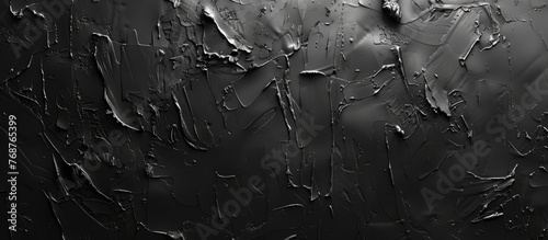 This black and white image captures the textured layers of paint on a concrete wall. The contrast between the dark background and the white paint creates a striking visual effect.