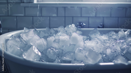 A chilly scene of a bathtub filled with ice cubes, suggesting a cold plunge for heat relief or therapy. photo