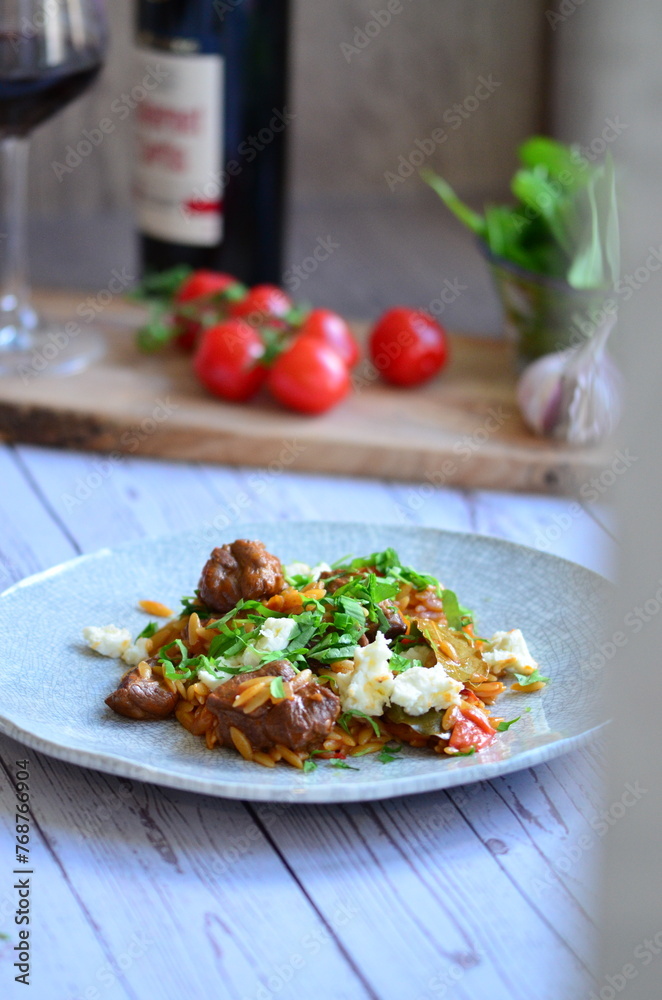 Rice with lamb meat and vegetables on a plate on a wooden table Rice with lamb meat and vegetables on a plate on a wooden table