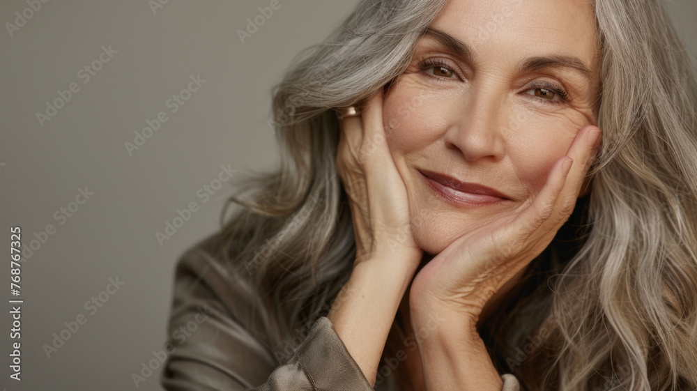 Fototapeta premium A mature woman's portrait exudes elegance and life experience with a confident and contented smile.