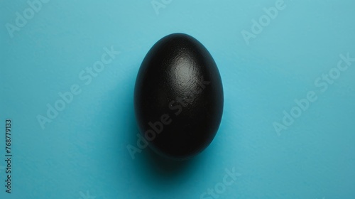 black egg on blue background.