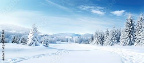 Scenic view of winter mountains covered in snow with visible ski tracks on the slopes © vxnaghiyev