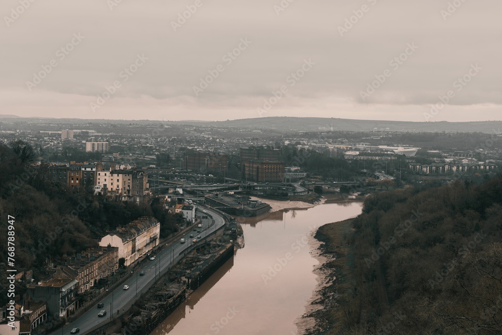 Aerial view of Avon river surrounded by trees and green on a cloudy day in Bristol, United Kingdom