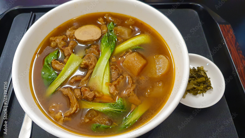 Taiwanese Beef Noodle Soup With Suan Cai (Pickled Mustard Greens) On Tray. Taiwanese Beef Noodle Soup With Suan Cai (Pickled Mustard Greens) On Tray.