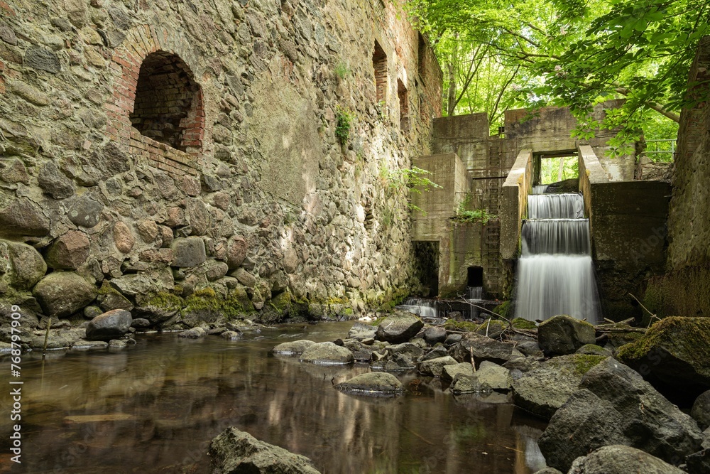 Long exposure shot of an old and abandoned mill ruin, situated deep in a forest in Wanzka, Germany