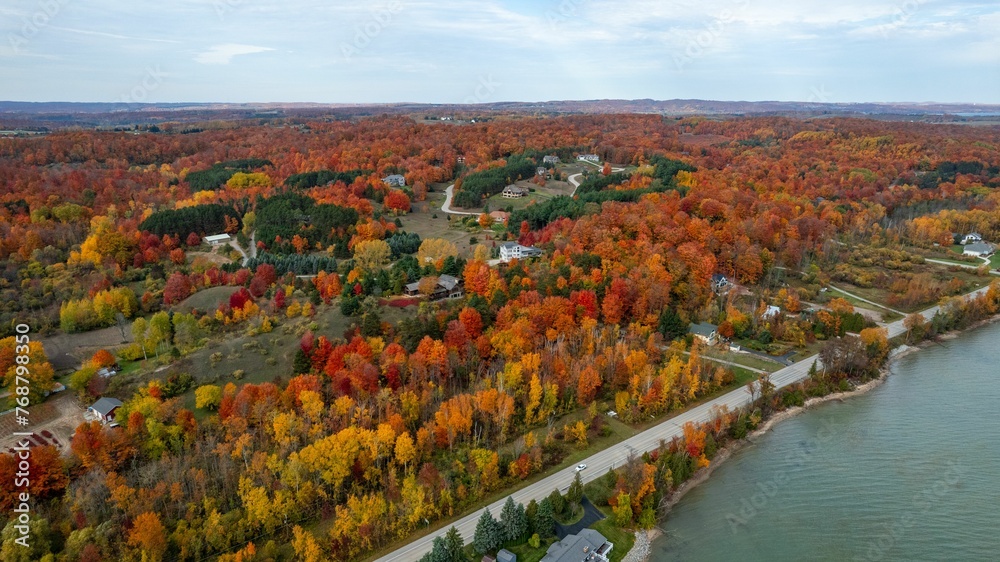 Aerial view of an autumnal scene of trees on the banks of a Cut River, in Michigan