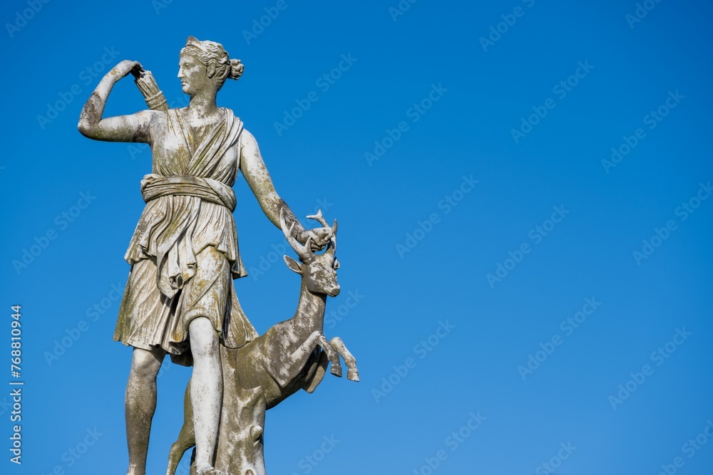 Statue of the goddess Artemis against blue sky Statue of the goddess Artemis against blue sky