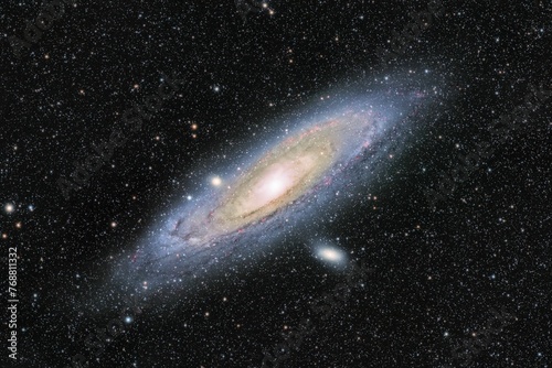 galaxy with a big barred disk and white stars in the background photo