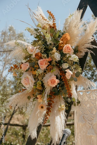 Vibrant bouquet of flowers arranged artfully in the center of a white aisle.