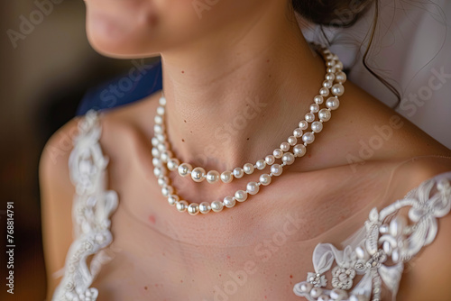 Necklace from pearls on the neck of bride 