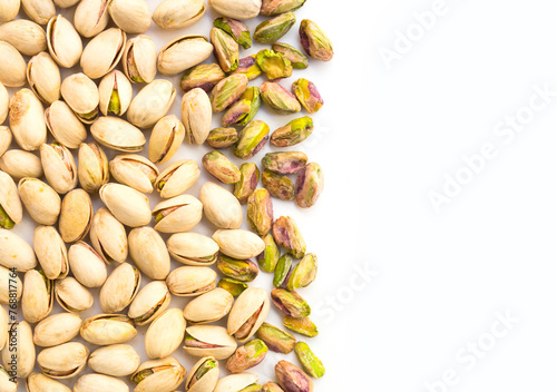 Roasted pistachio nuts on a white background and place for inscription