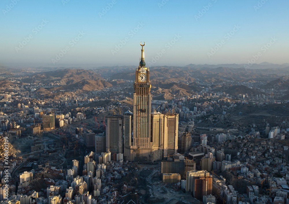 Aerial view of the vibrant urban cityscape of Saudi Arabia, featuring a towering spire.
