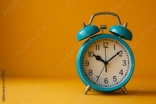 A blue clock face with an alarm set pastel yellow background