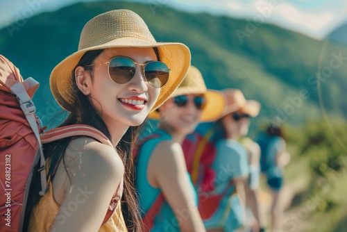 Happy group young asian american tourists woman wearing beach hat, sunglasses and backpacks going to travel on holidays on mountains background